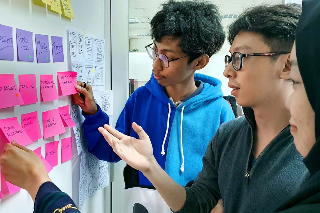 A group of students gather in front of the whiteboard