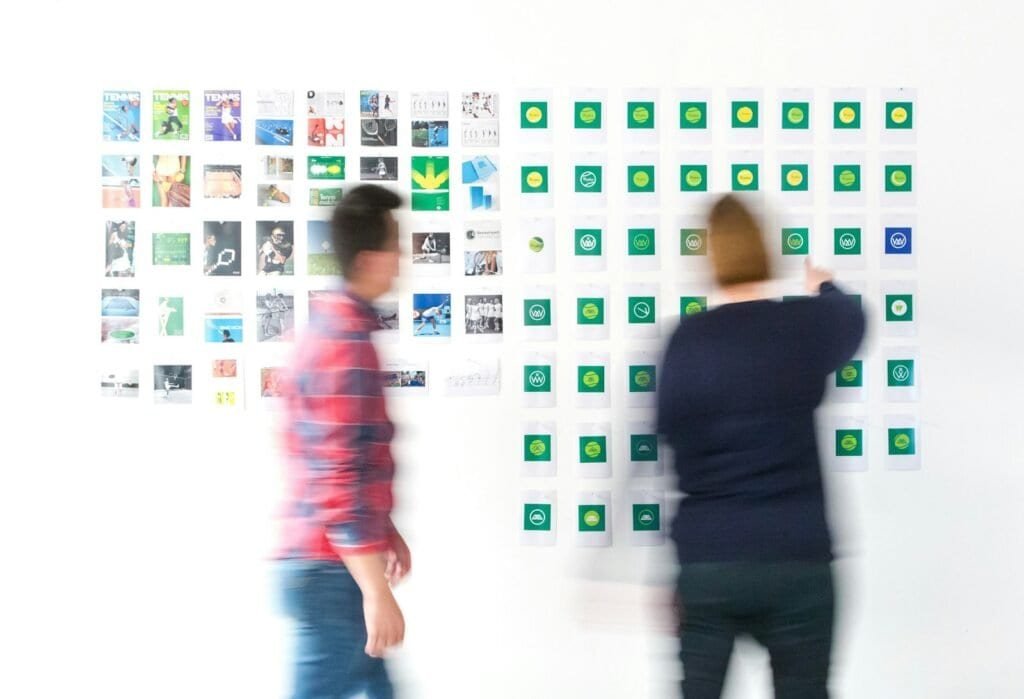 Two designers collaborating on creative direction at a shared desk