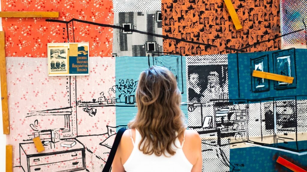 A creative studying a wall of pinned visual references, the kind of work you learn in an art direction course