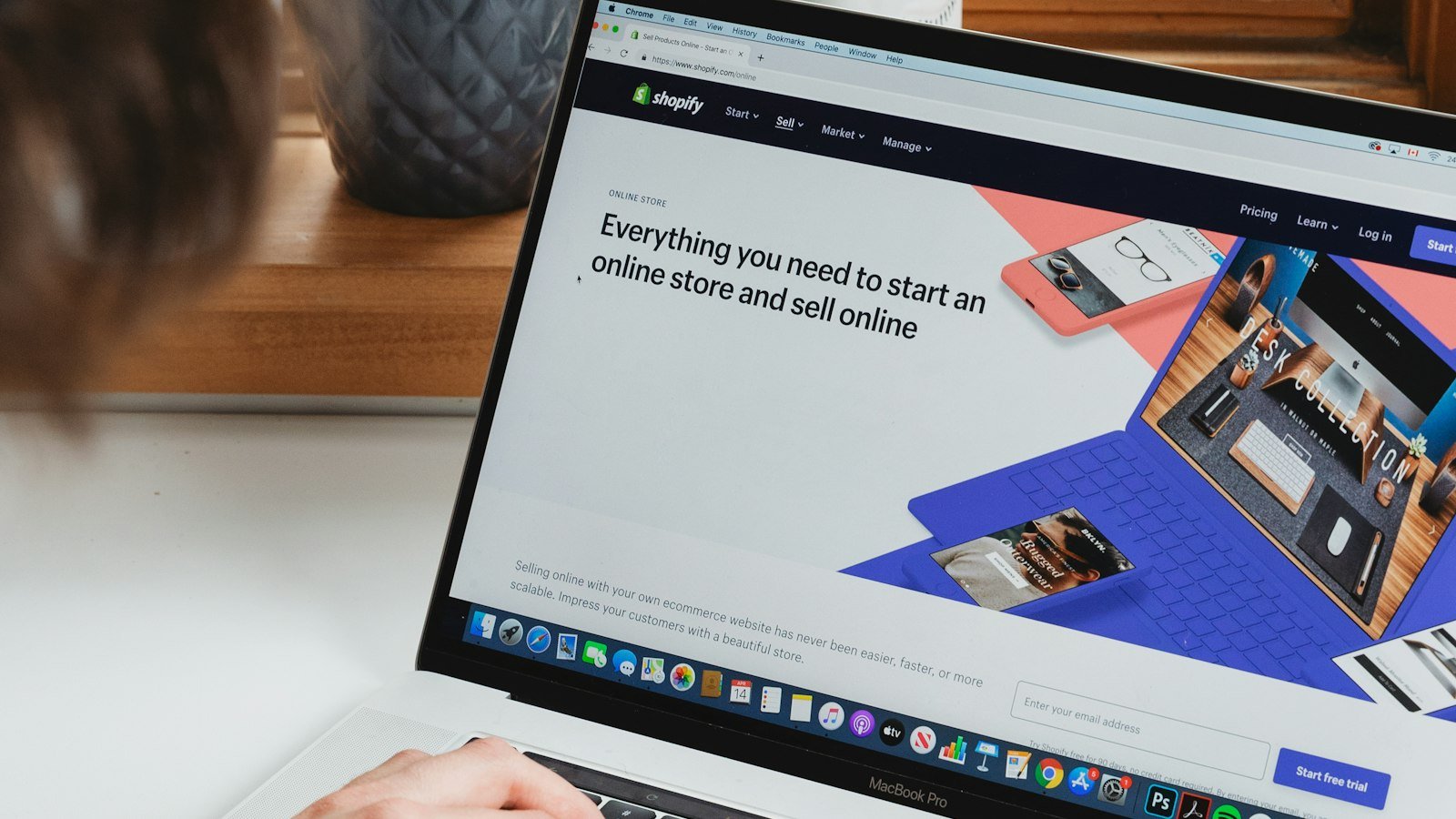 Designer reviewing UI/UX portfolio examples on a laptop
