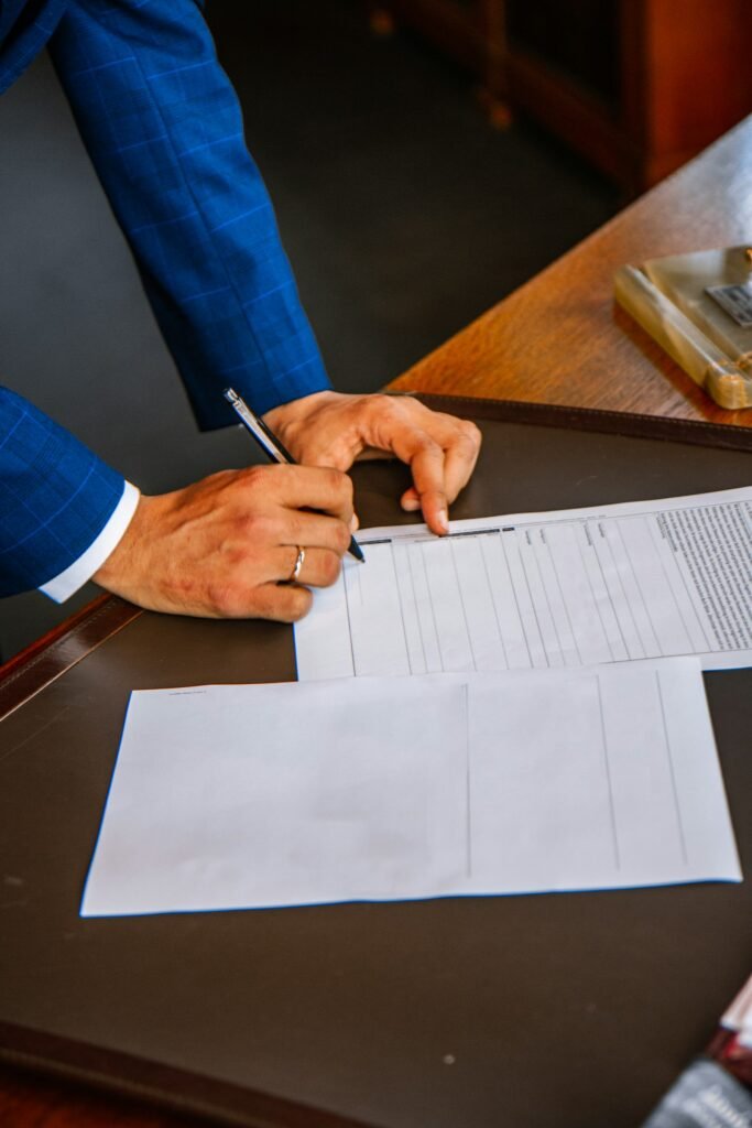 Person filling out a form, showing the fine print behind a UI/UX bootcamp job guarantee