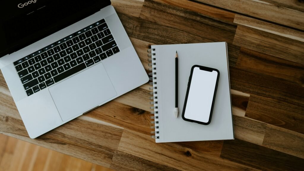 Laptop and tablet on a desk, a UX designer's workspace for building a portfolio after bootcamp